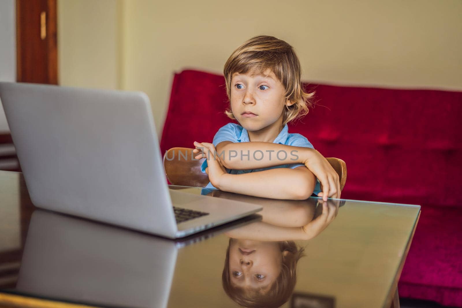 Boy studying online at home using laptop. Studying during quarantine. Global pandemic covid19 virus.