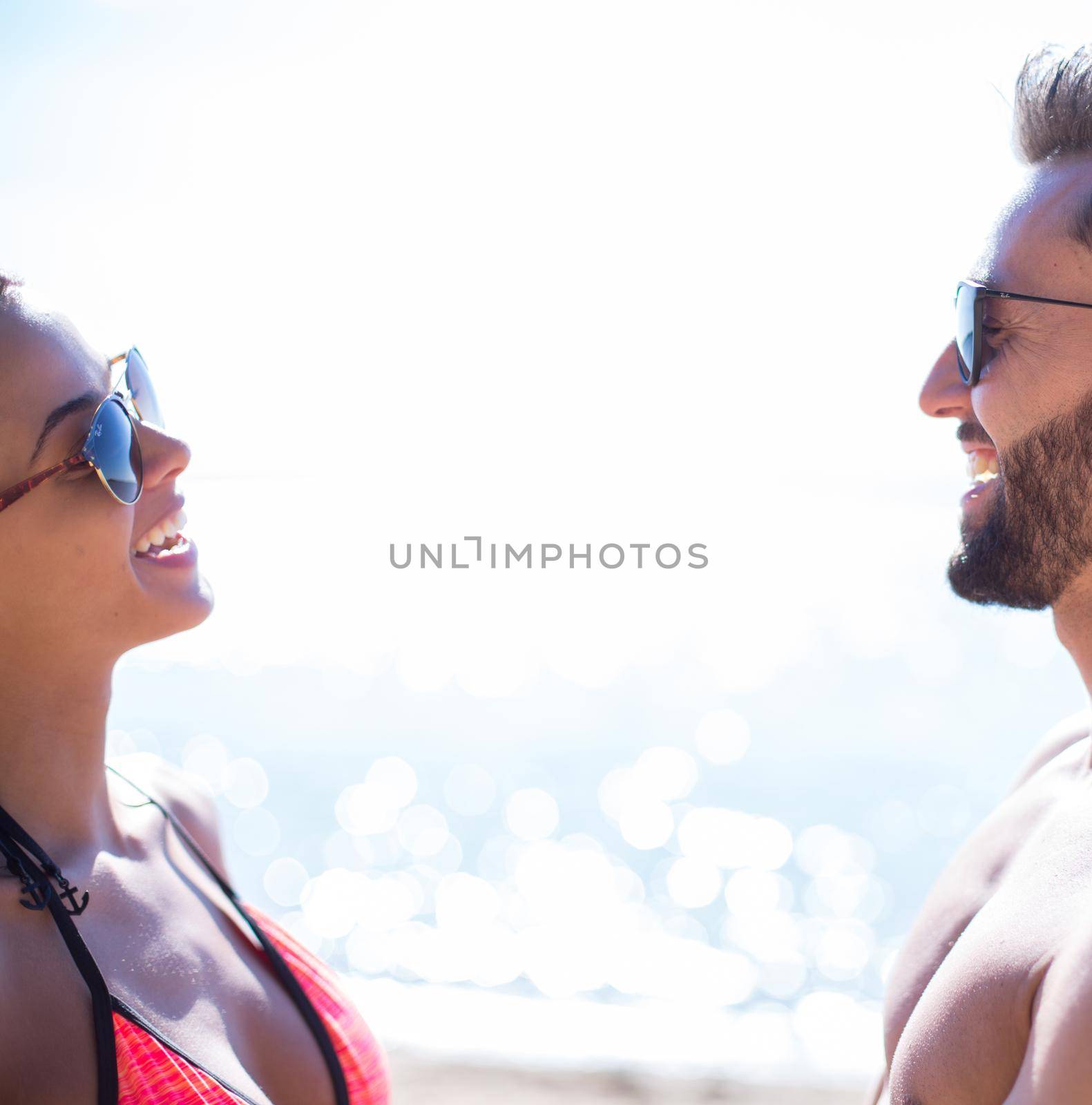 Happy couple spending carefree time on the beach outdoors. by asdf