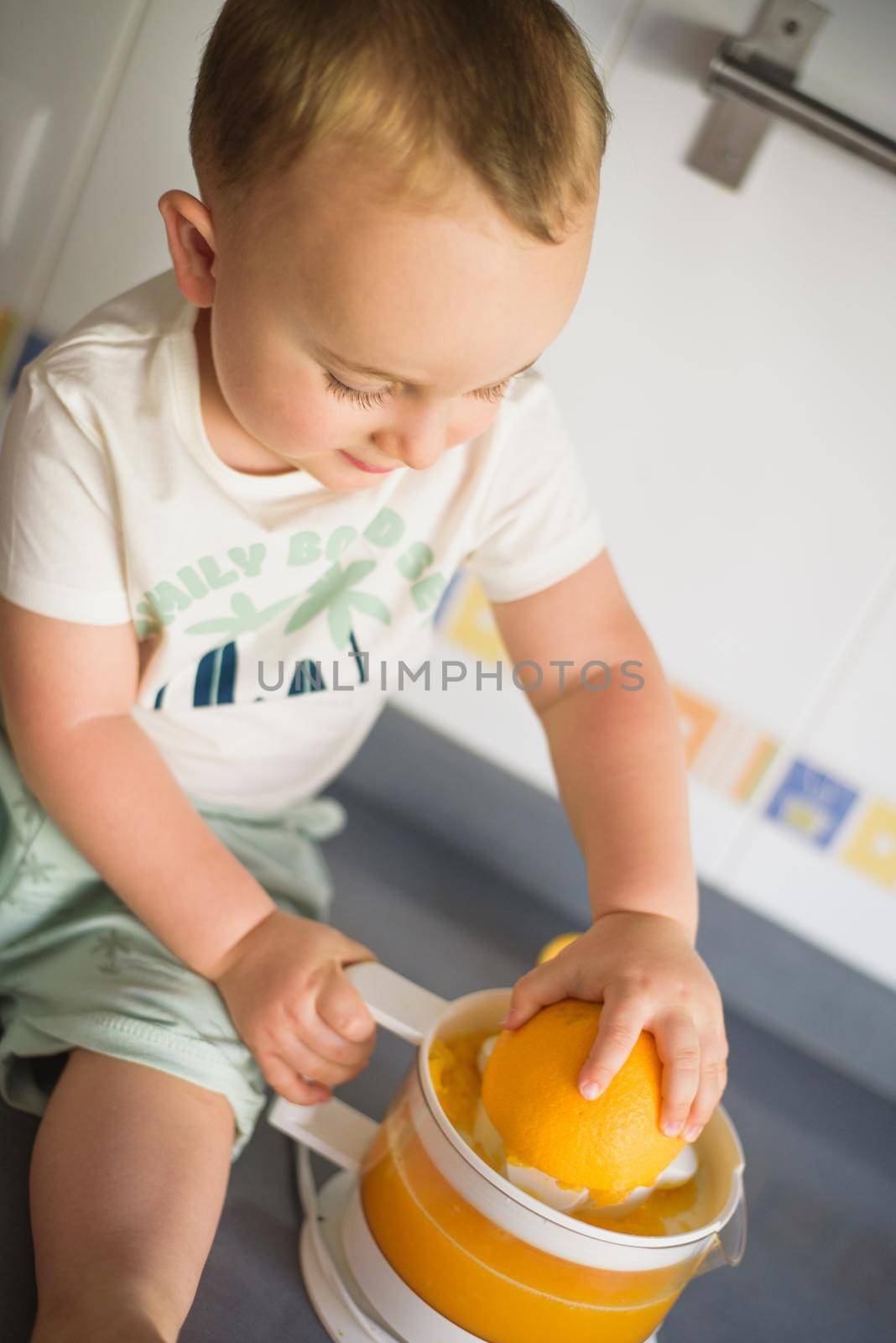 cute kids making carrot and apple juice with a juice extractor