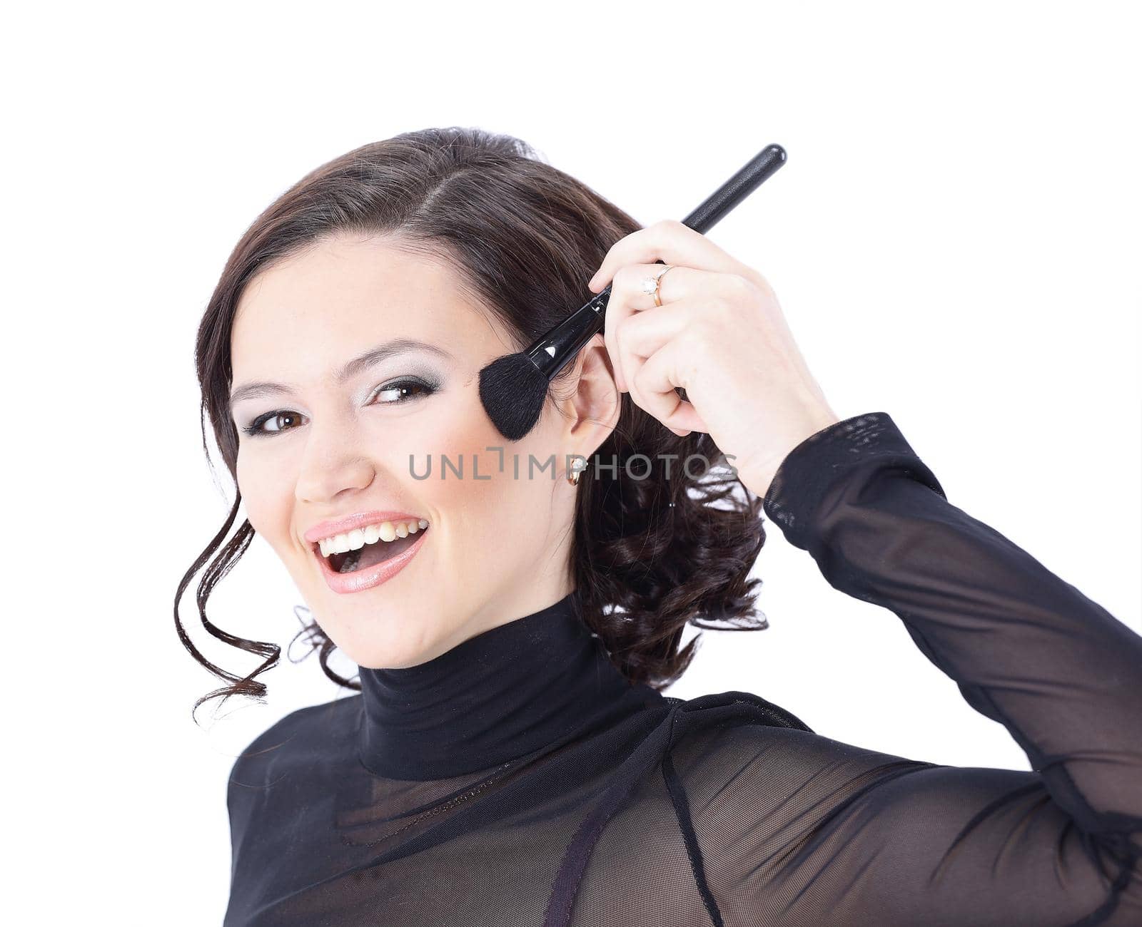Beautiful woman with makeup brush near her face - isolated on white