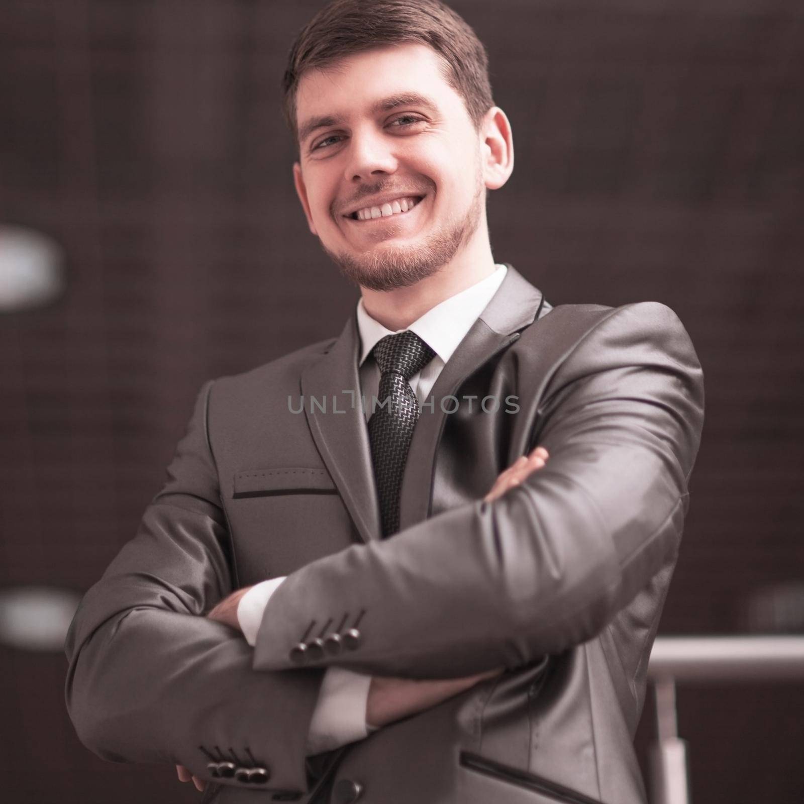 confident businessman in a business suit in the office by SmartPhotoLab