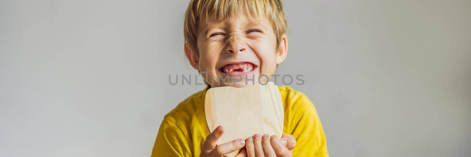 A boy, 6 years old, holds a box for milk teeth. Change of teeth. BANNER, LONG FORMAT