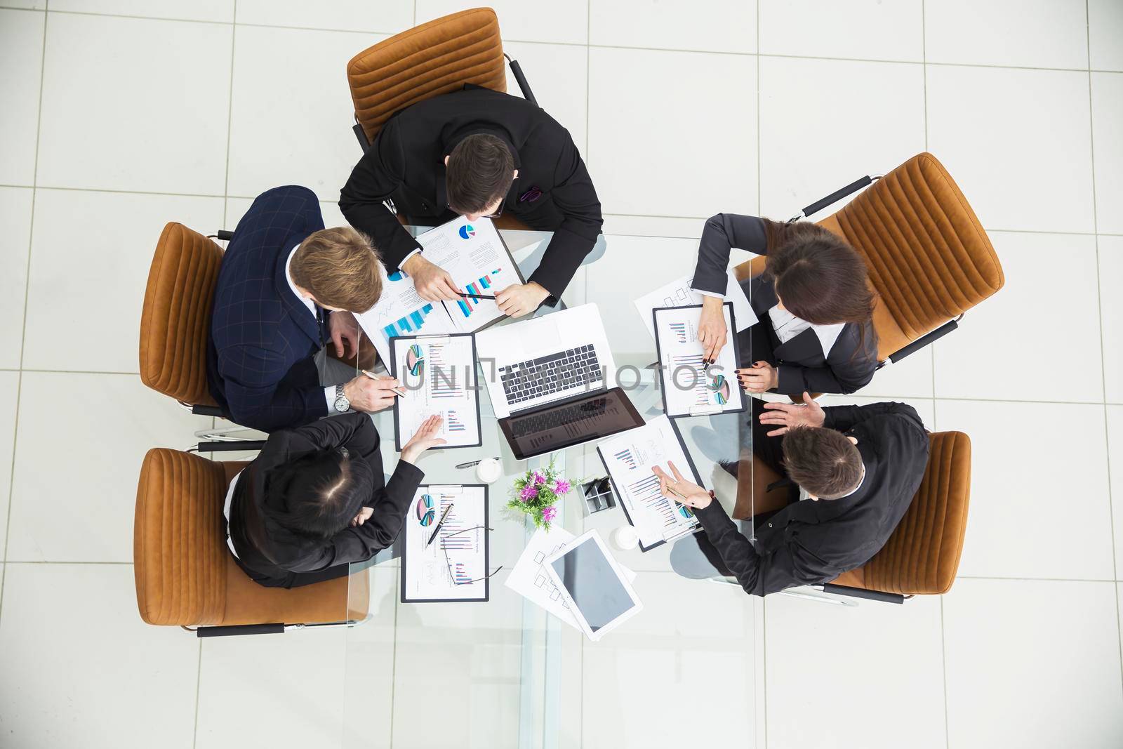 top view of successful business team discussing marketing schemes and financial schedules for the development of the company.the photo is a blank space for your text