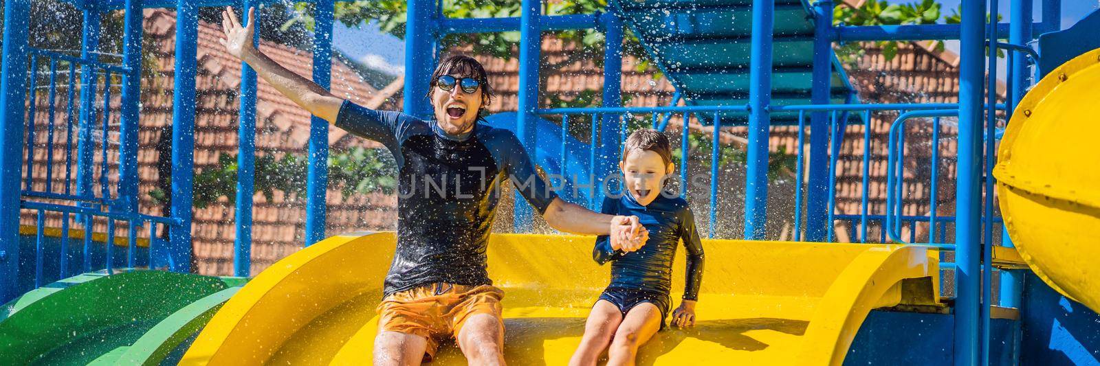Father and son on a water slide in the water park BANNER, LONG FORMAT by galitskaya