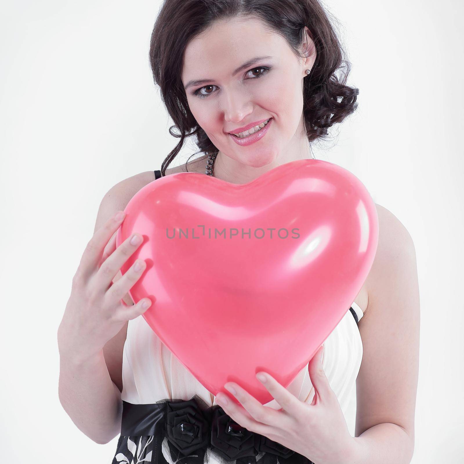 beautiful young woman holding red balloon heart. photo with copy space