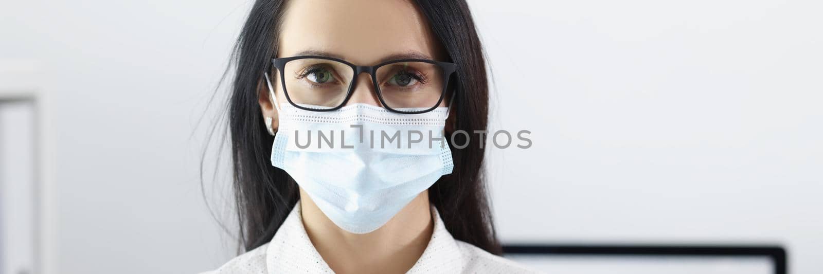 Portrait of pretty young woman wearing sterile mask. Preventive measures to protect against virus. Social distancing and quarantine time idea. Coronavirus outbreak concept