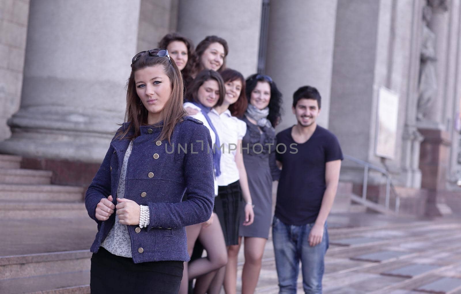 girl student on the background of the team of friends .photo with copy space