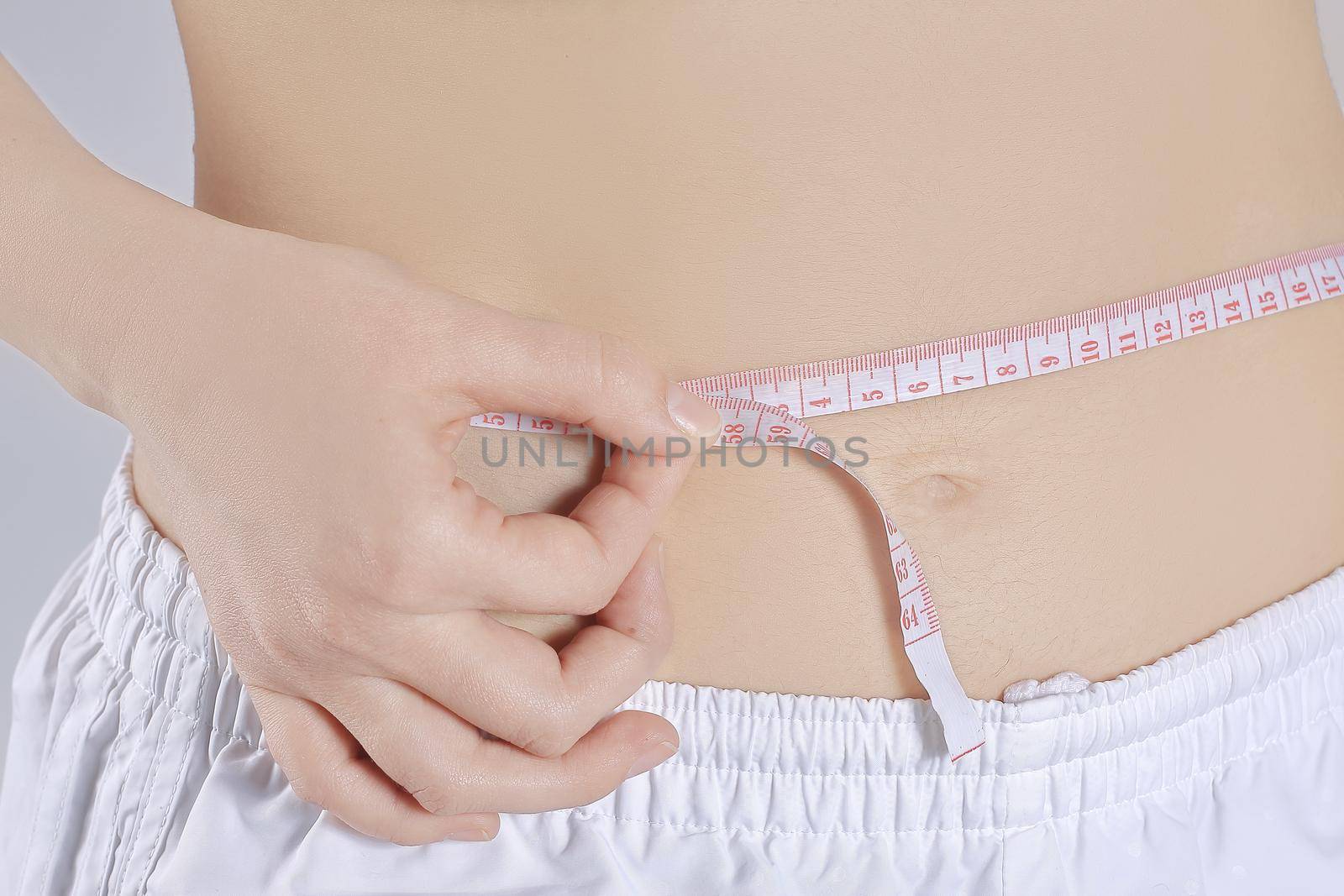 Woman measuring her waistline. Perfect Slim Body. Diet
