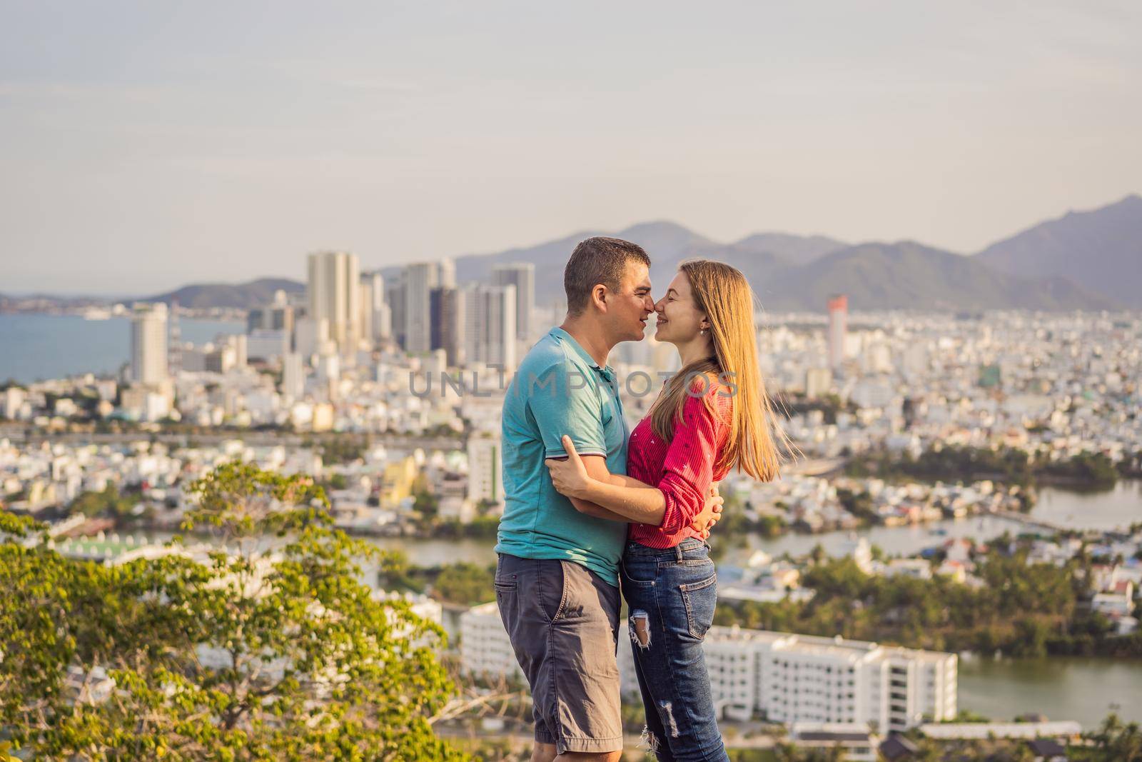 Happy couple tourists on the background of Nha Trang city. Travel to Vietnam Concept.