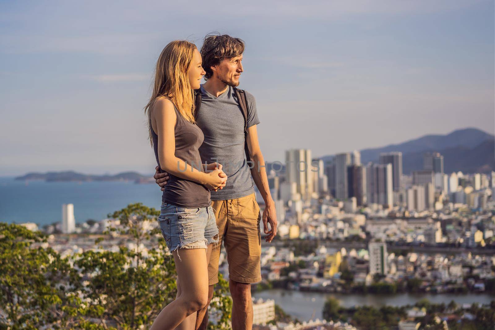 Happy couple tourists on the background of Nha Trang city. Travel to Vietnam Concept by galitskaya