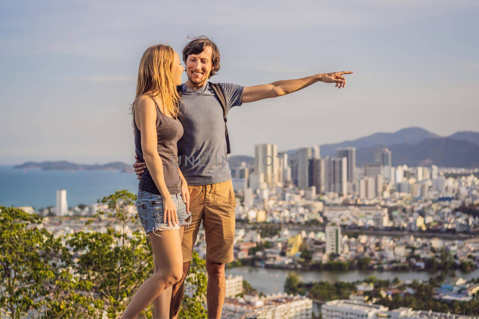 Happy couple tourists on the background of Nha Trang city. Travel to Vietnam Concept by galitskaya