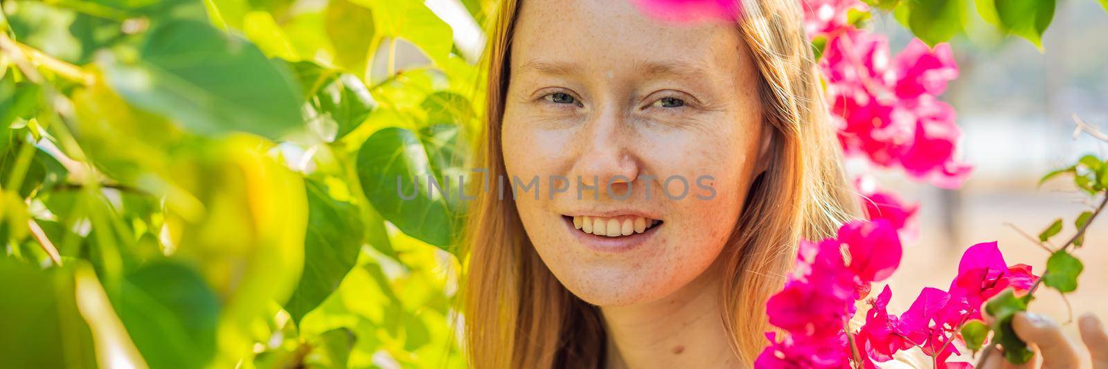 I love my skin. A young woman with freckles, moles, scars and facial wrinkles loves her skin, enjoys life and walks in a beautiful park BANNER, LONG FORMAT by galitskaya