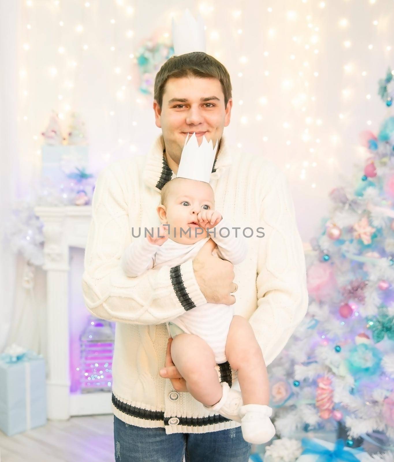 father and son standing next to a Christmas tree.happy fatherhood