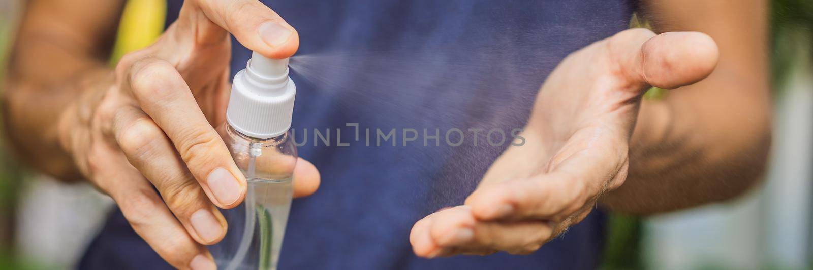 Men's hands using wash hand sanitizer gel. BANNER, LONG FORMAT