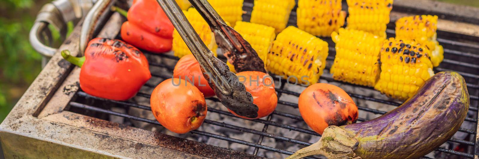 Man with tongs cooking on a back yard barbecue. BANNER, LONG FORMAT