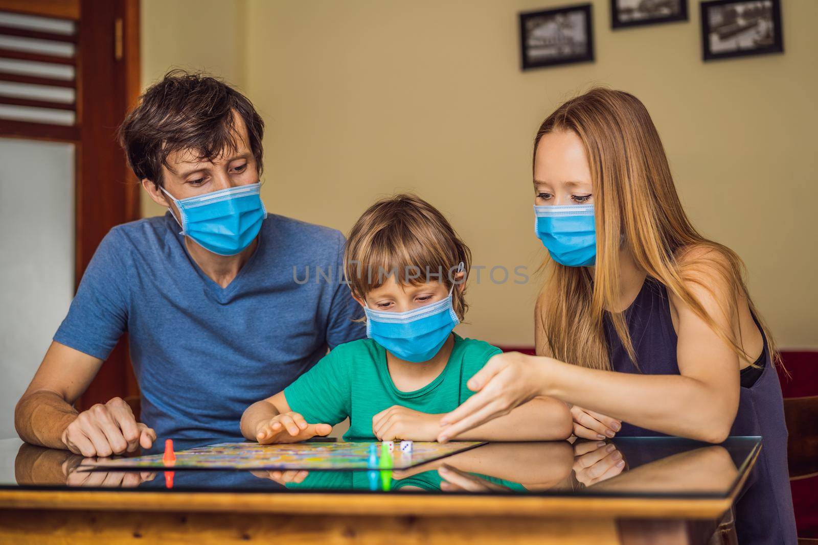 Happy Family Playing Board Game At Home. Stay at home due to quarantine. Coronovirus infection.