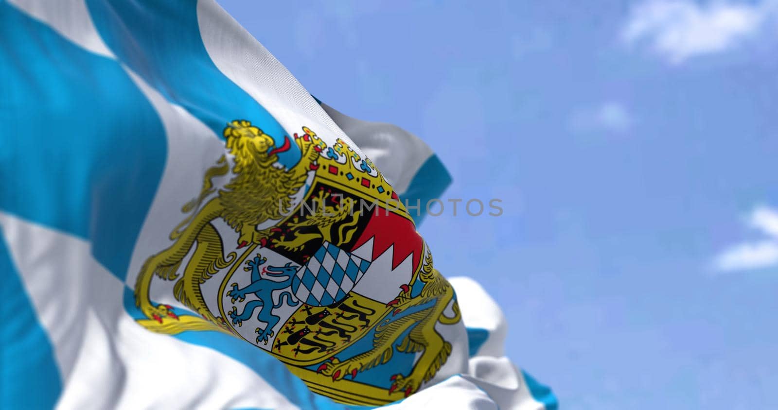 The flag of Bavaria waving in the wind on a clear day. Bavaria is a state in the south-east of Germany by rarrarorro