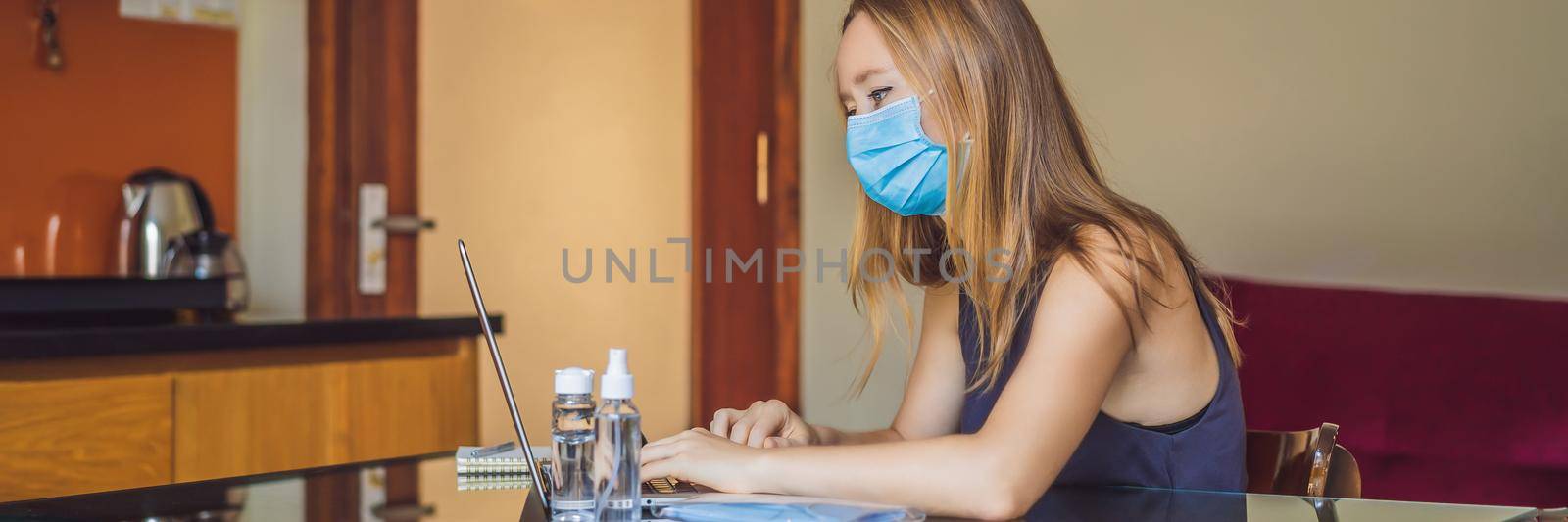 Coronavirus. Young business woman working from home wearing protective mask. Business woman in quarantine for coronavirus wearing protective mask. Working from home. BANNER, LONG FORMAT