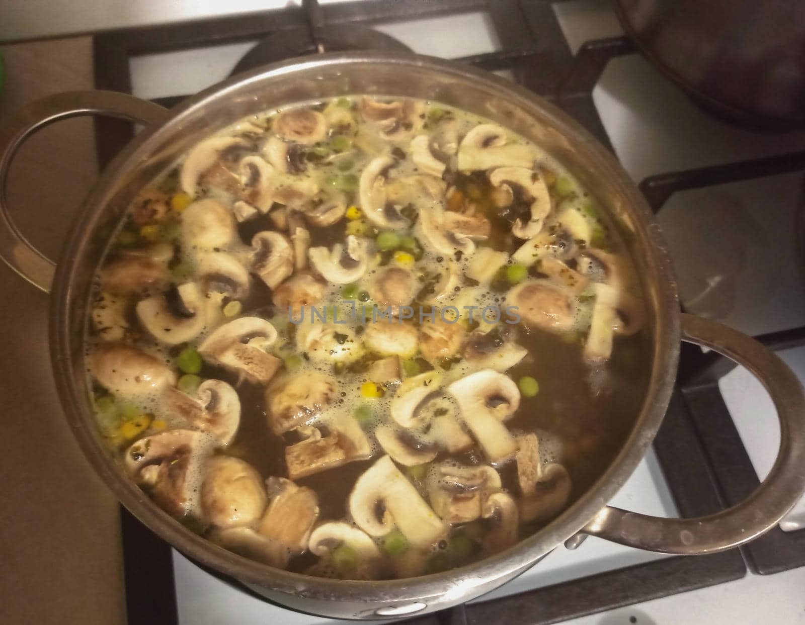 Cooking delicious homemade mushroom soup cream in a saucepan by biruzza