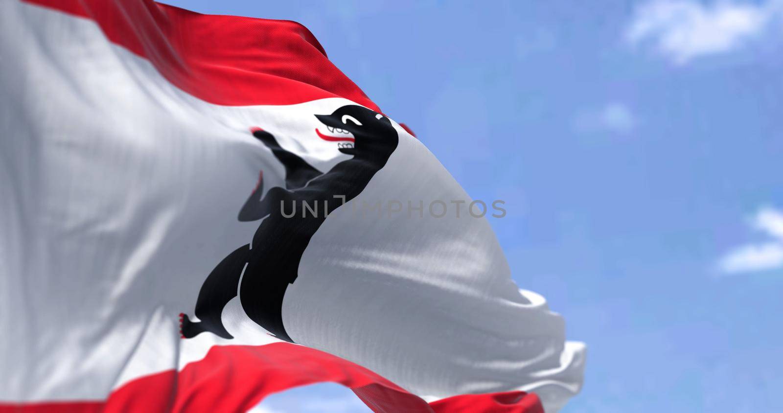 The civil flag of Berlin waving in the wind on a clear day by rarrarorro