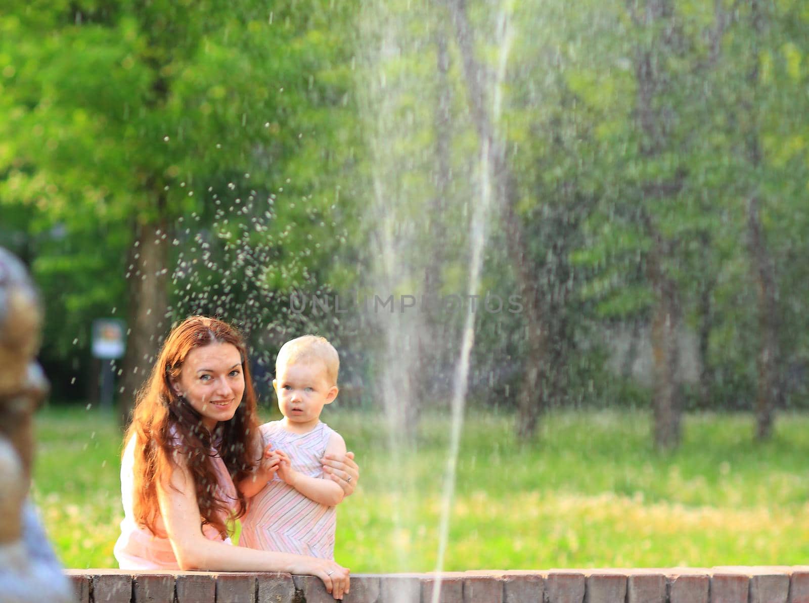 Happy mother and daughter laughing together outdoors by SmartPhotoLab