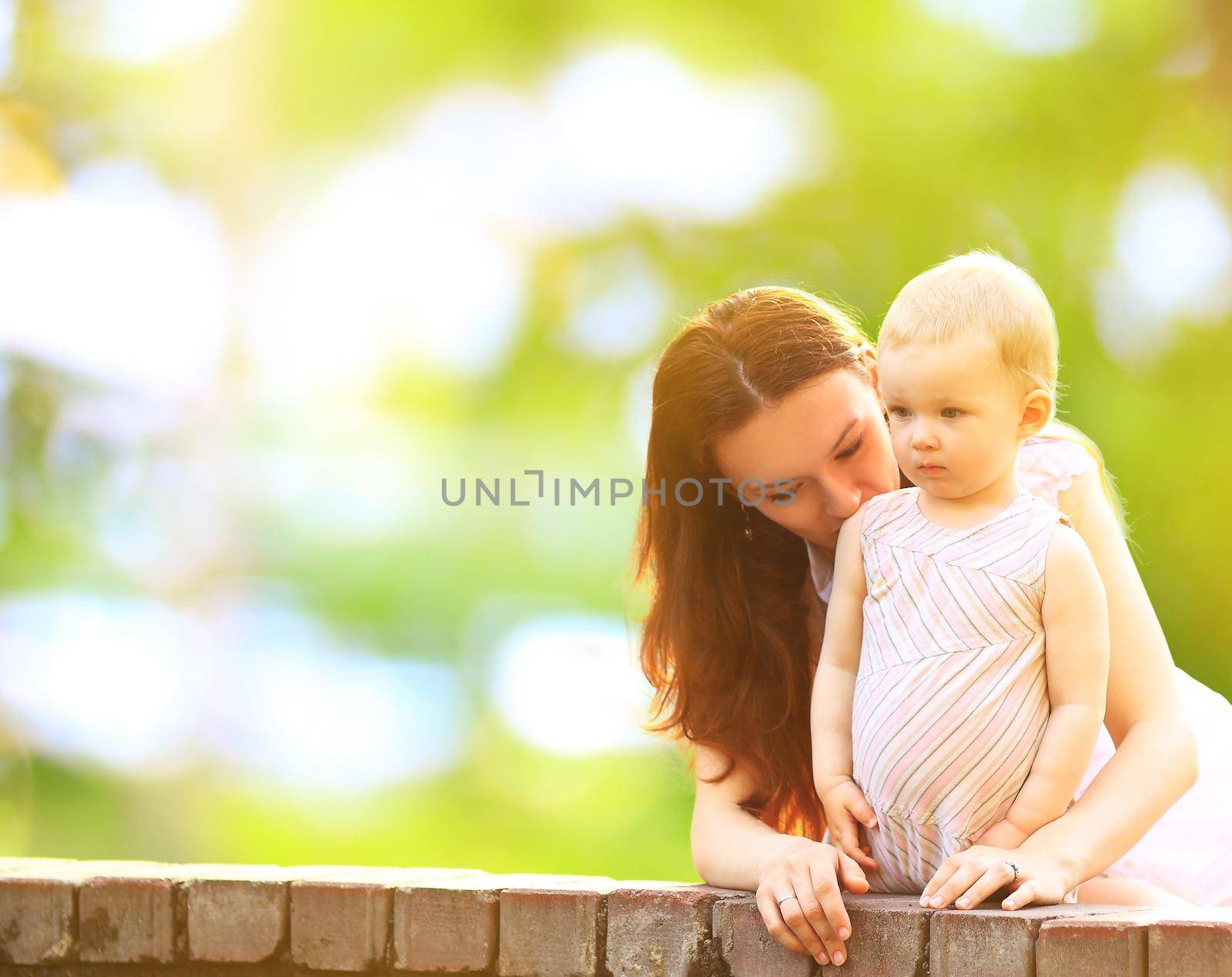 young mother and baby outdoor on a warm summer day