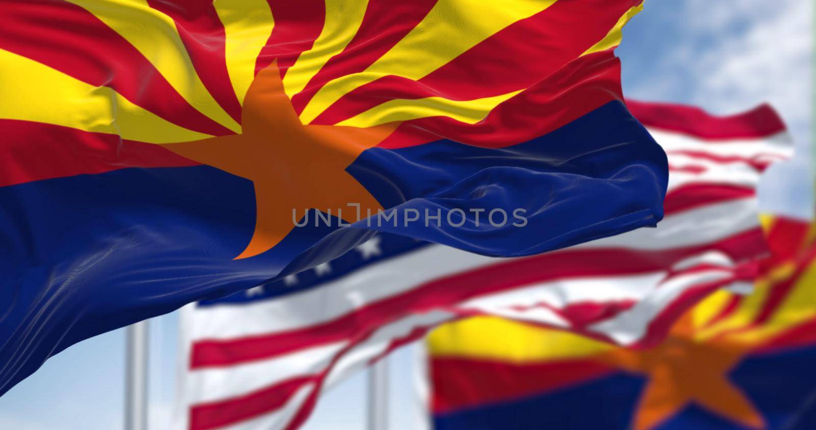 The flags of the Arizona state and United States waving in the wind. is a state in the Western United States. Democracy and independence. American state.