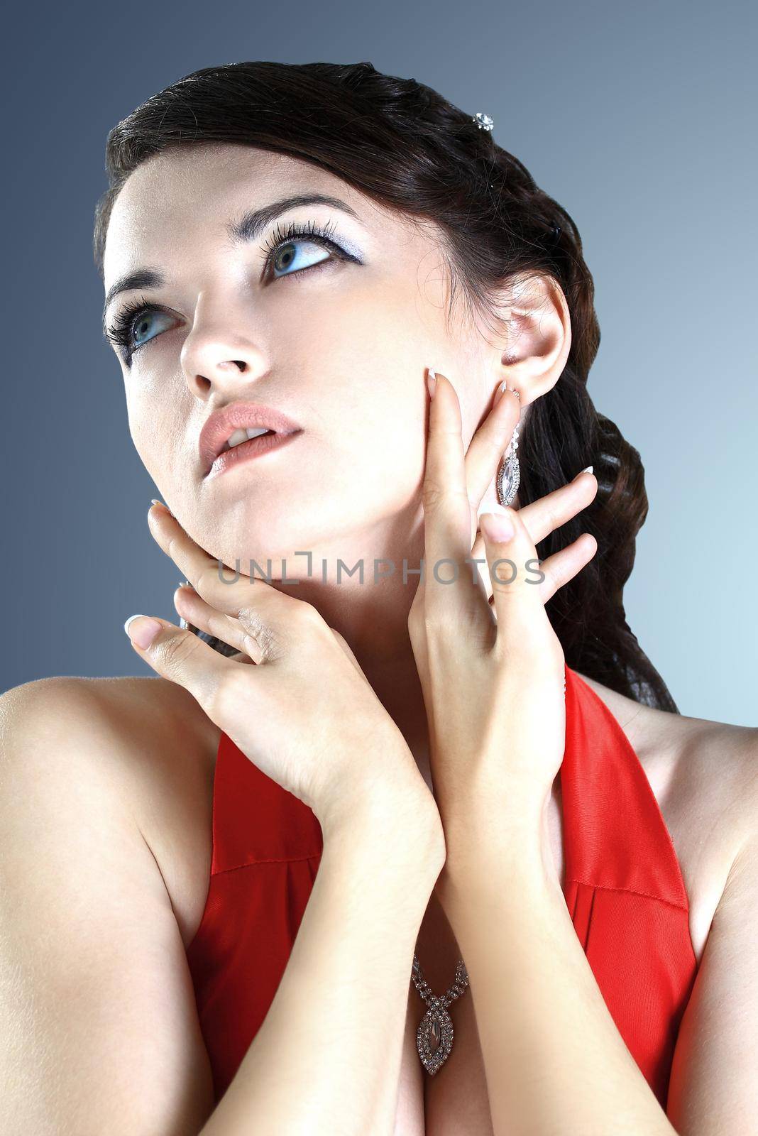 Beautiful girl in the red dress. Isolated on a black background.