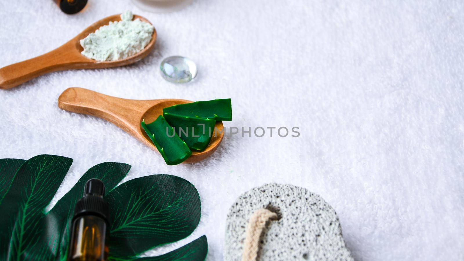 Beauty and fashion concept with spa set and palm leaves. Bio herbal green cosmetic arrangement. Frame copy space. Trendy self care products. Organic concept.