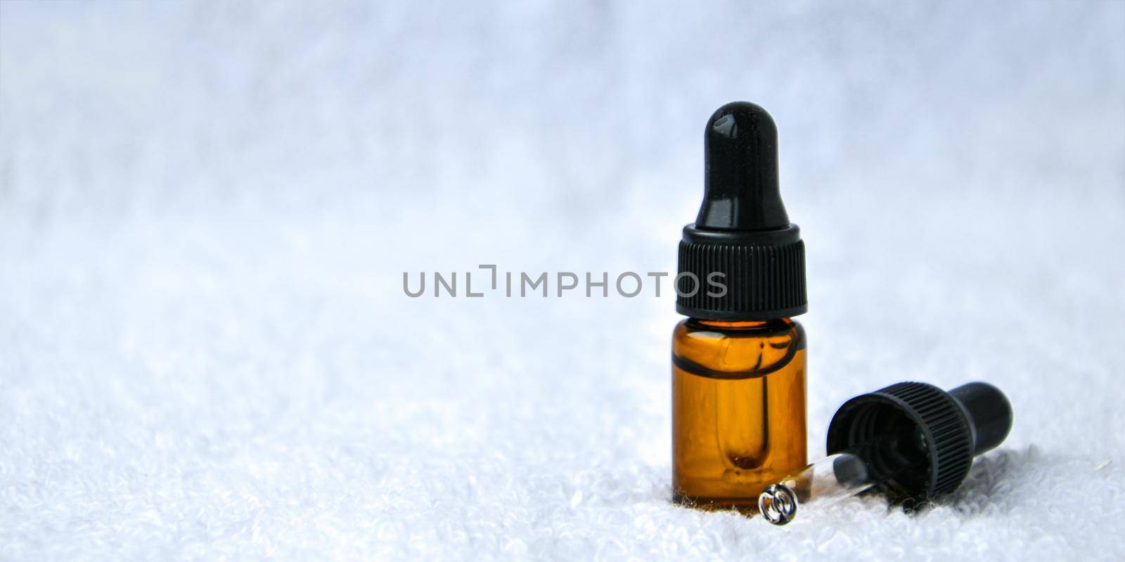 Dropper glass bottle skincare essential oil product for mock up in minimal style on white background with monstera leaf. Copy space. by anna_stasiia