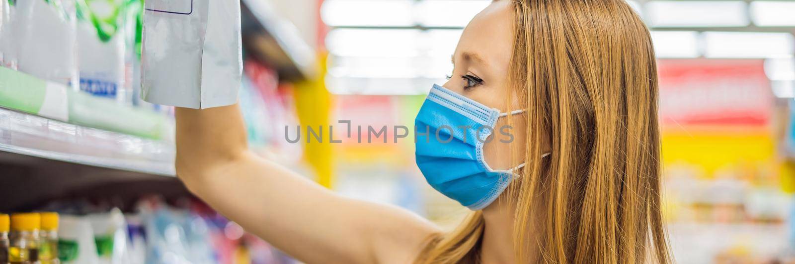 Alarmed female wears medical mask against coronavirus while grocery shopping in supermarket or store- health, safety and pandemic concept - young woman wearing protective mask and stockpiling food. BANNER, LONG FORMAT