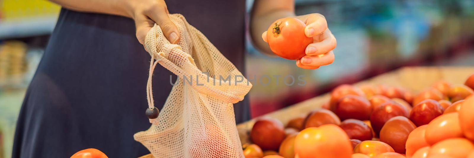 A woman chooses tomatoes in a supermarket without using a plastic bag. Reusable bag for buying vegetables. Zero waste concept. BANNER, LONG FORMAT