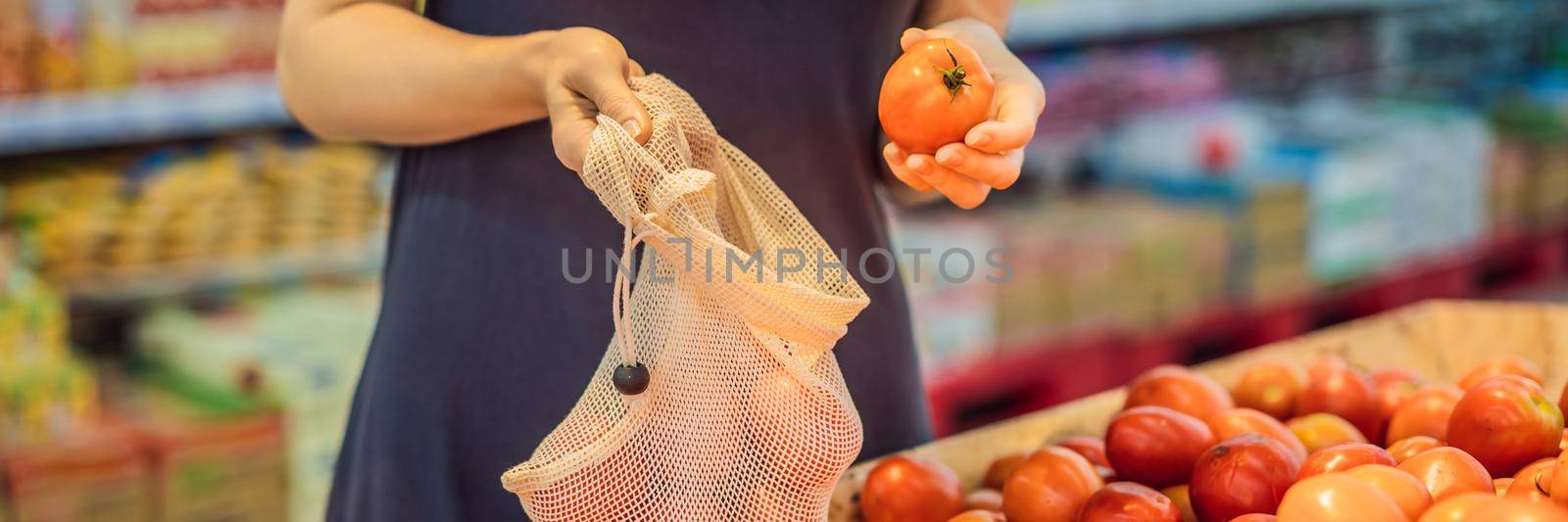 A woman chooses tomatoes in a supermarket without using a plastic bag. Reusable bag for buying vegetables. Zero waste concept. BANNER, LONG FORMAT