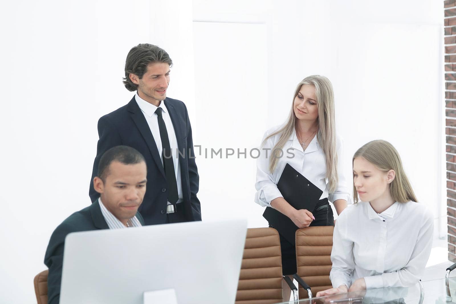closeup.the employees are talking in a modern office.office life