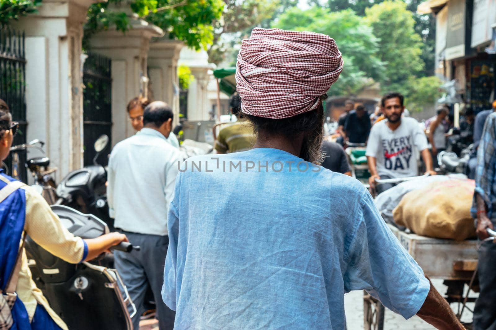 Indian unrecognizable back man with turban on his head. by Peruphotoart