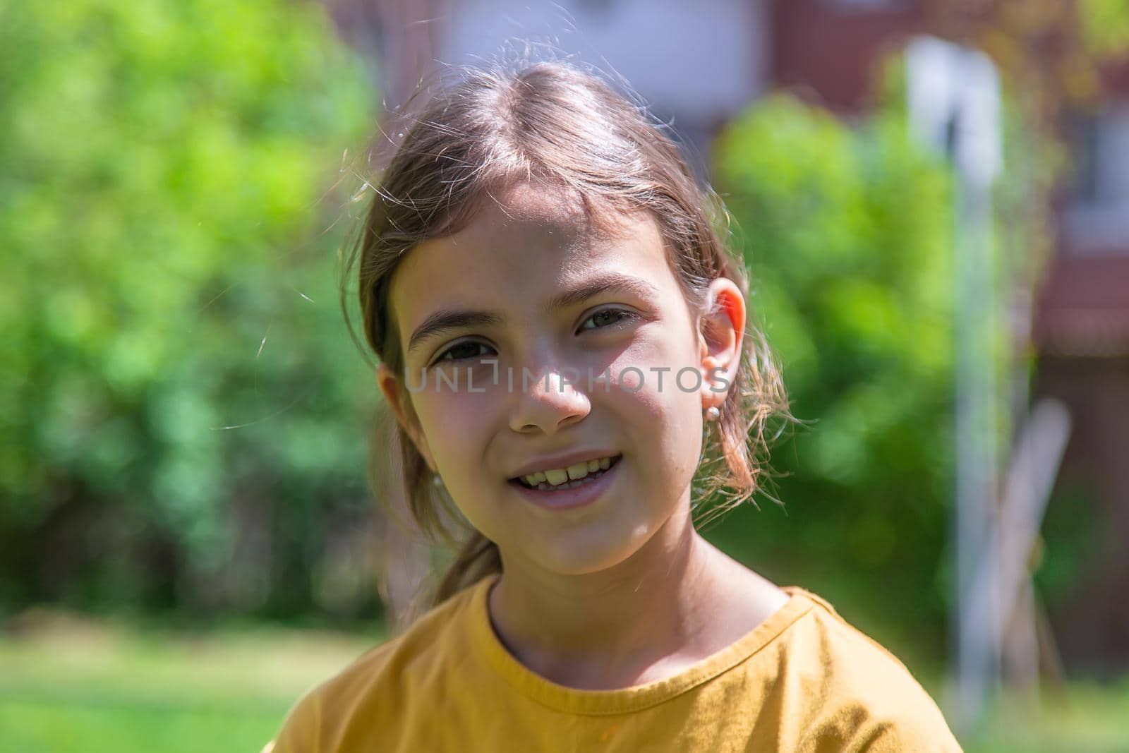 The child laughs in the park. Selective focus. by yanadjana