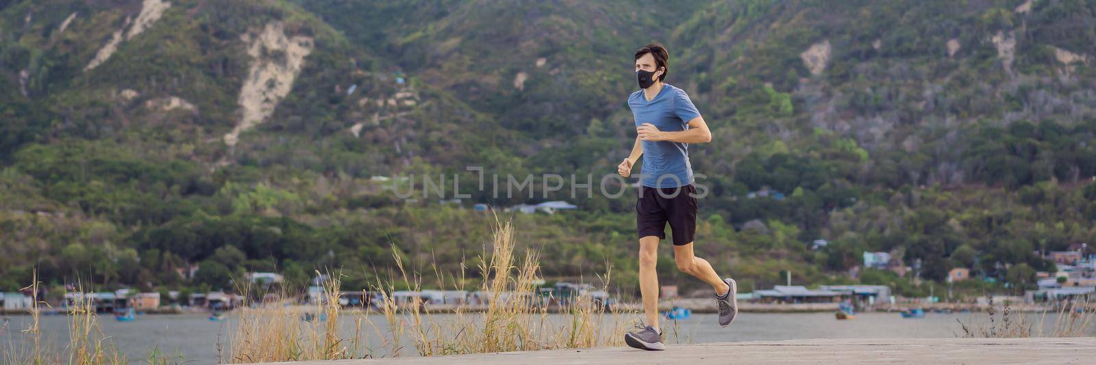 Runner wearing medical mask, Coronavirus pandemic Covid-19. Sport, Active life in quarantine surgical sterilizing face mask protection. Outdoor run on athletics track in Corona Outbreak. BANNER, LONG FORMAT