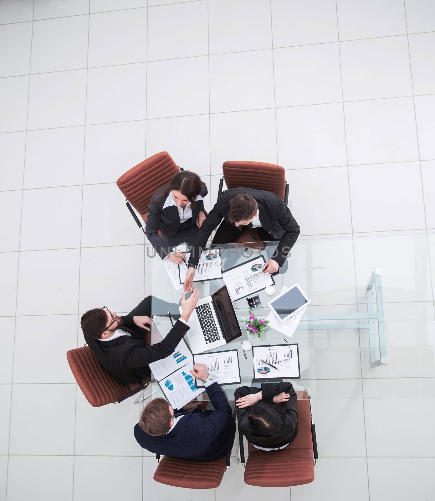 top view of successful business team discussing marketing schemes and financial schedules for the development of the company.the photo is a blank space for your text