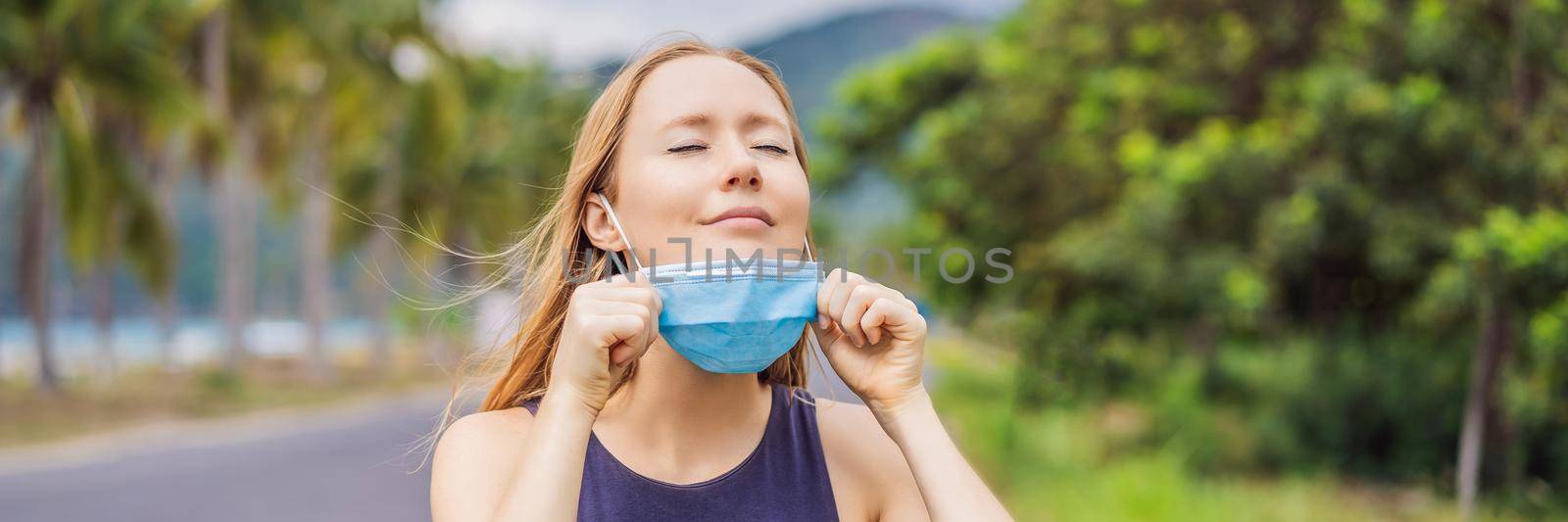 Quarantine is over concept. Woman taking off mask outdoor. We are safe. Coronavirus ended. We won. No more quarantine. Breathe deep. Take off the mask. Coronavirus is over BANNER, LONG FORMAT by galitskaya