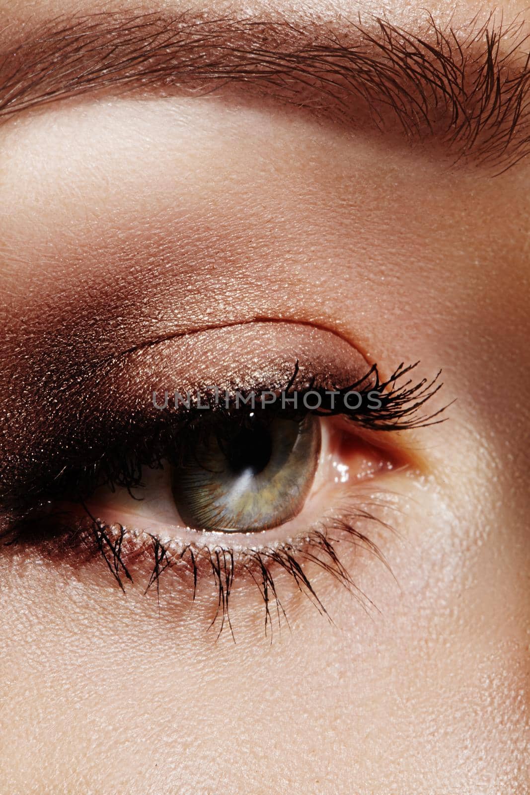 Close-up macro of beautiful female eye with perfect shape eyebrows. Clean skin, fashion naturel make-up. Good vision by MarinaFrost