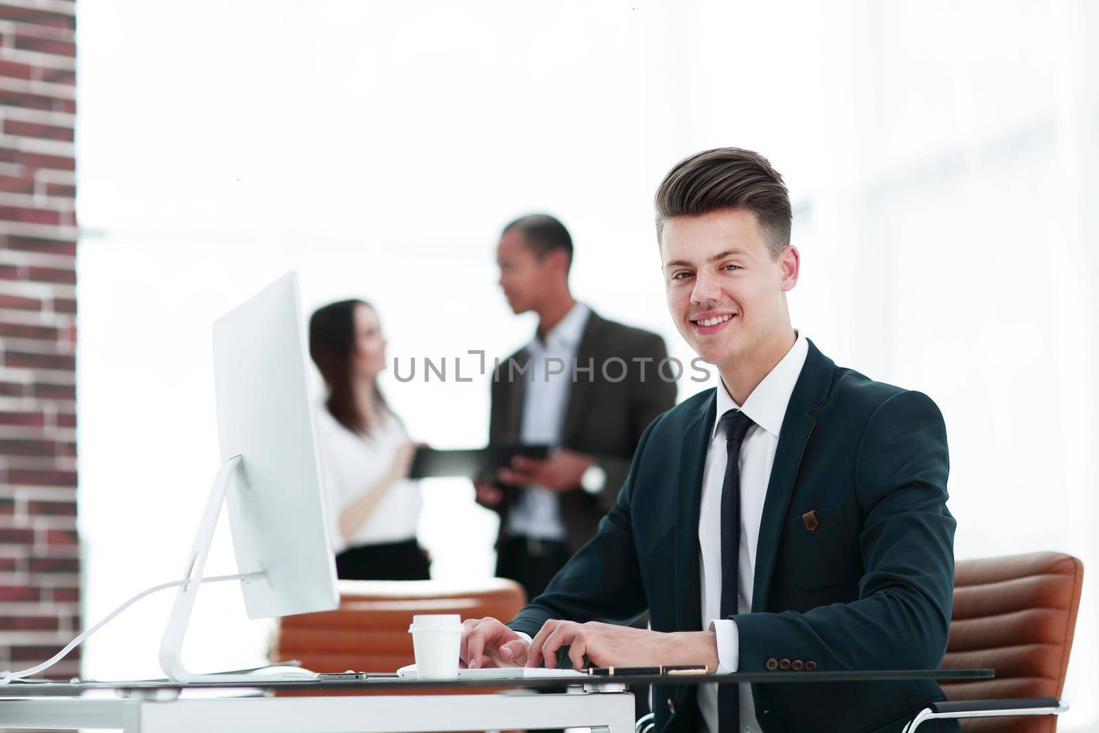 employee sitting behind a Desk in the office .photo with copy space