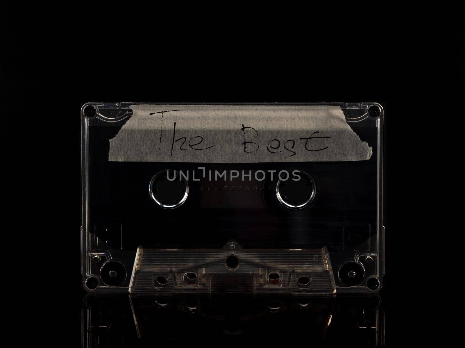 Old audio cassette on a black background. vintage