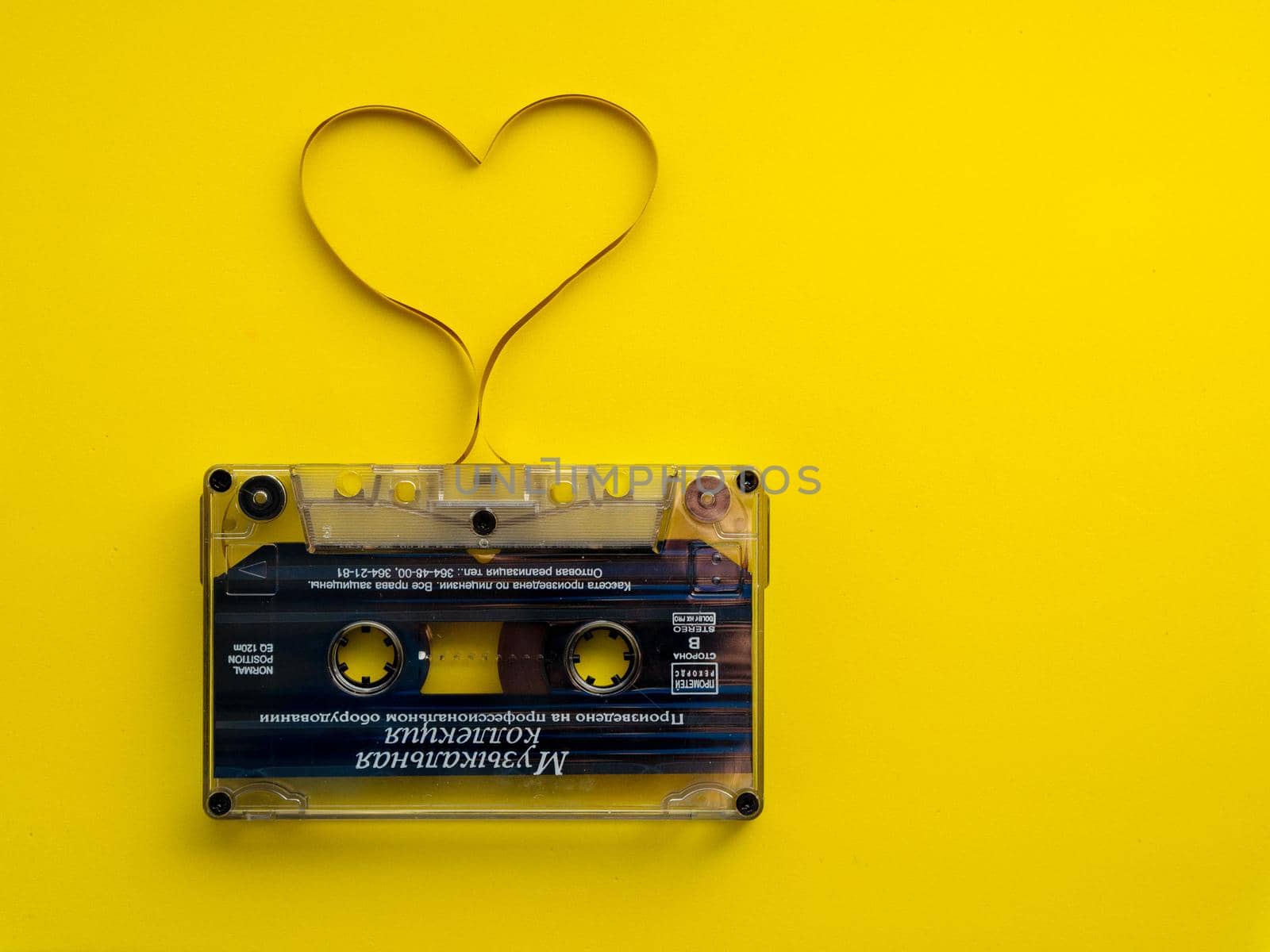 Audio cassette tape on yellow backgound.