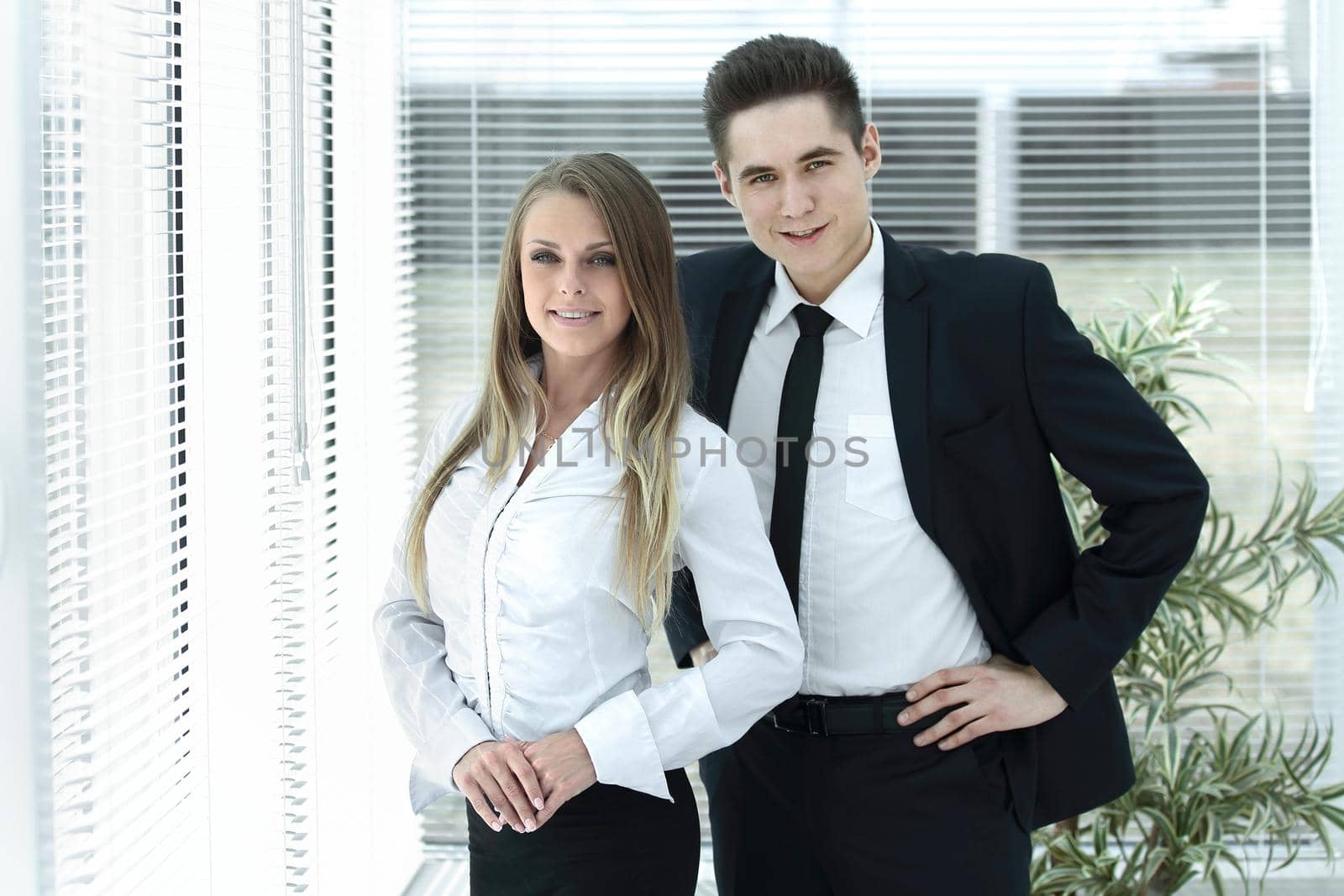 business couple standing in a modern office.photo with copy space