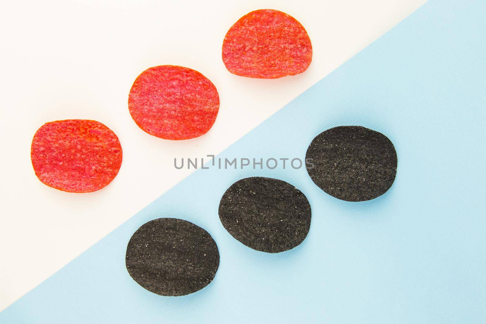 Red and black potato chips with salt, chili pepper. Isometric drawing. Chips background on white and blue background. by sfinks