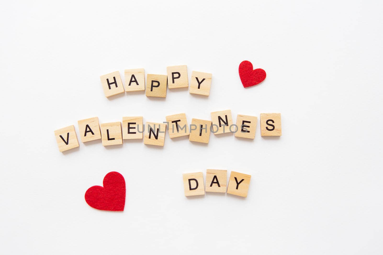 Postcard Happy Valentine's Day. Wooden lettering Happy Valentine's Day. Red heart on a white background