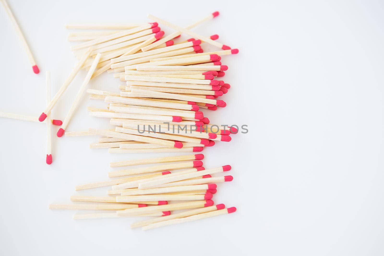 Long matches with a red head on a white background. by sfinks