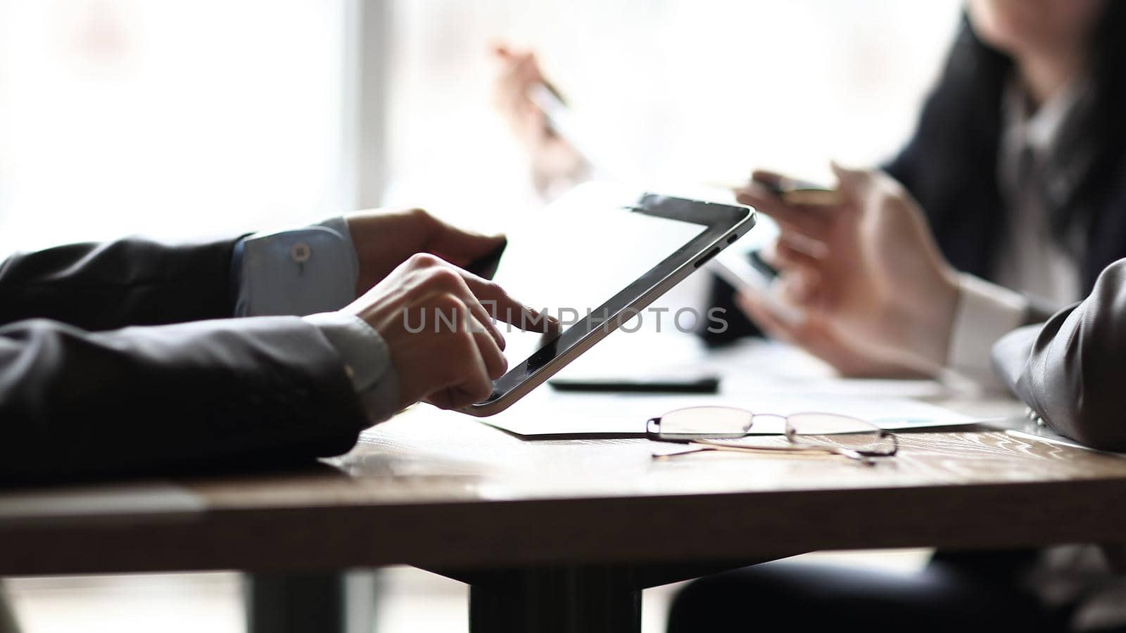 close up.business team sitting at the Desk by SmartPhotoLab