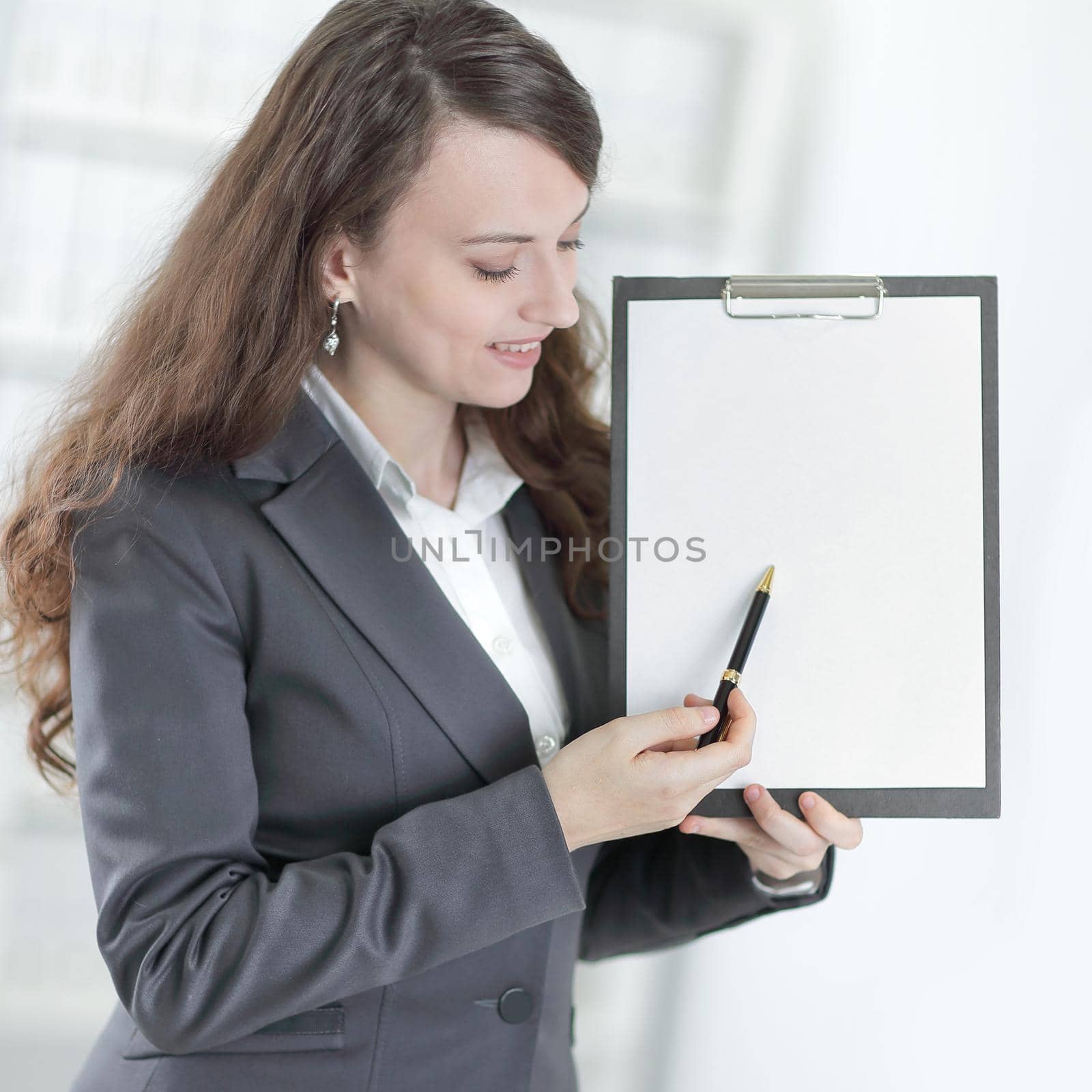 modern business woman pointing at blank sheet. by SmartPhotoLab