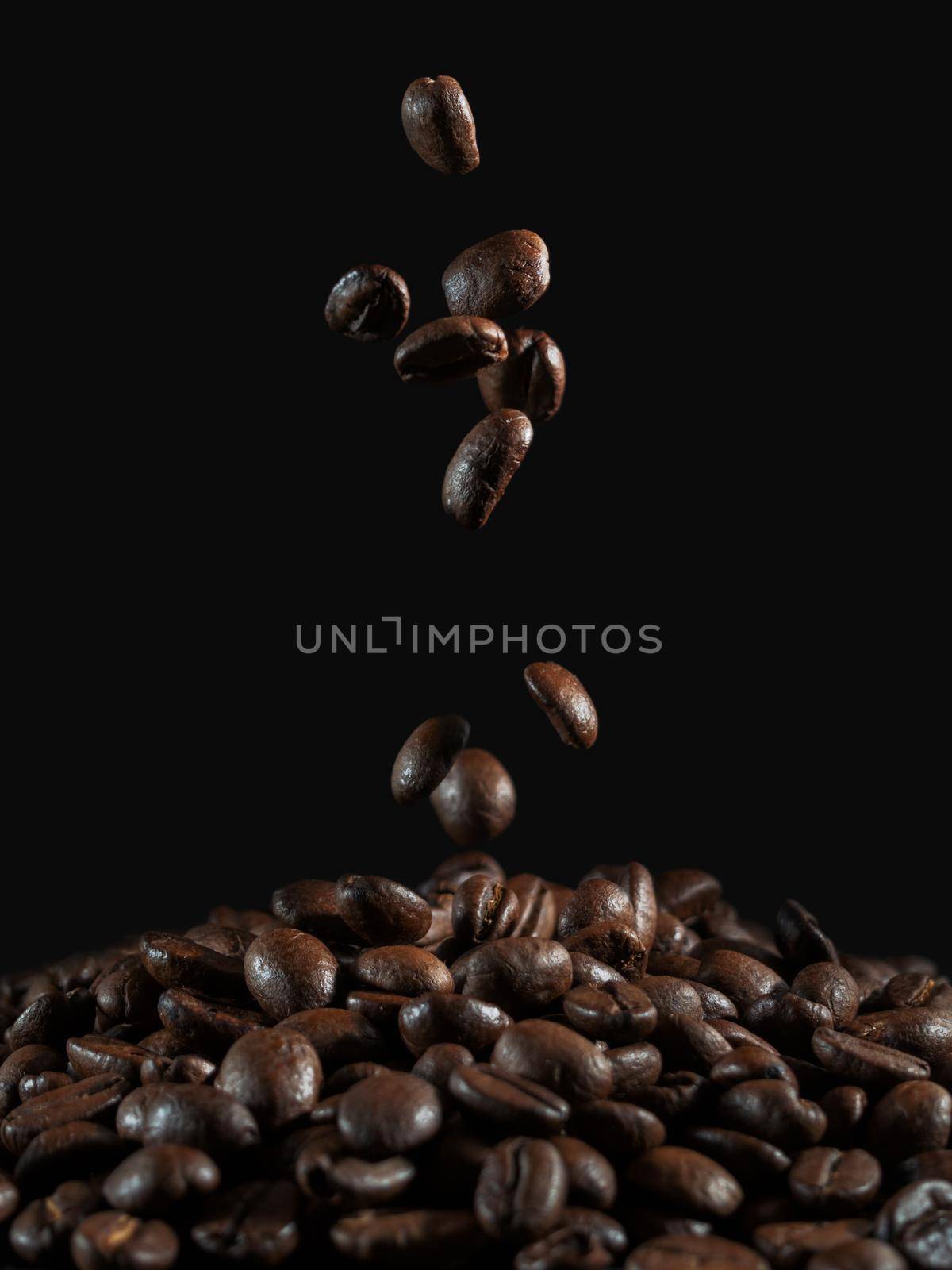 falling coffee beans on the dark background.